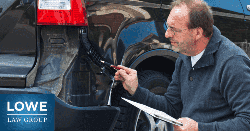 an insurance adjuster checking the damage on a car