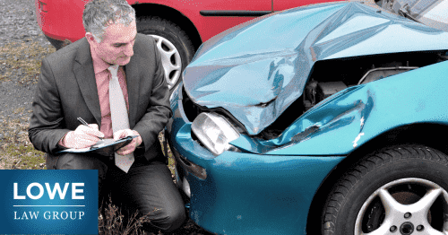 insurance adjuster examining damage on a car