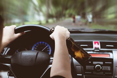 Man Driving with Bottle