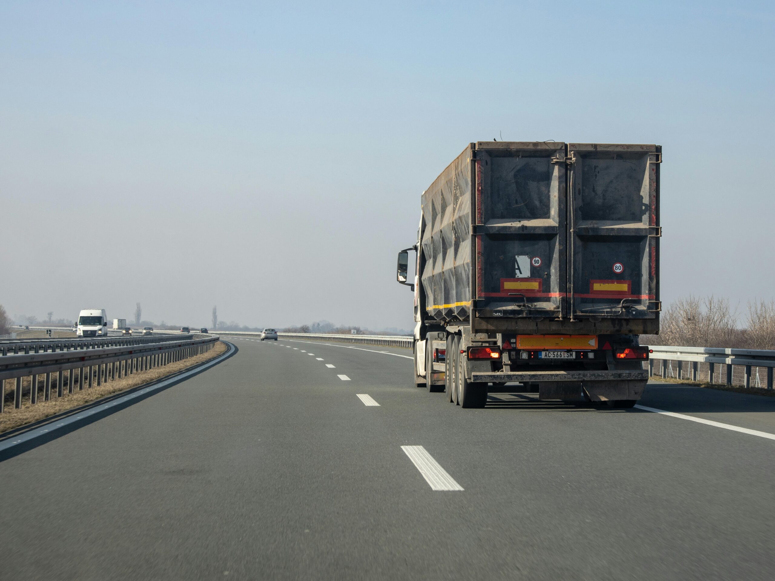 A commercial truck traveling on a highway, illustrating real-world conditions related to cases handled by a Lehi truck accident lawyer, including heavy traffic, commercial transport risks, and accident liability scenarios.